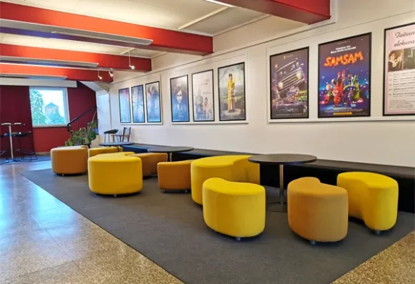 Yellow ALKIO stools in cinema lobby.